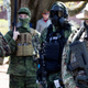 Heavily armed individuals, some associated with “Boogaloo,” protest coronavirus lockdowns in New Hampshire in May 2020.